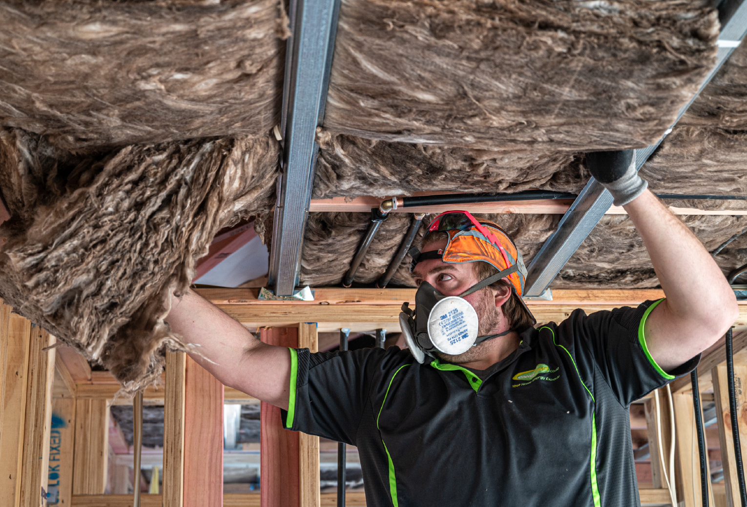 EnergySmart installer installing insulation into ceiling of new build
