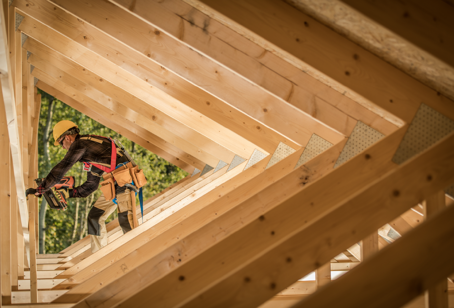 carpenter installing beams in ceiling